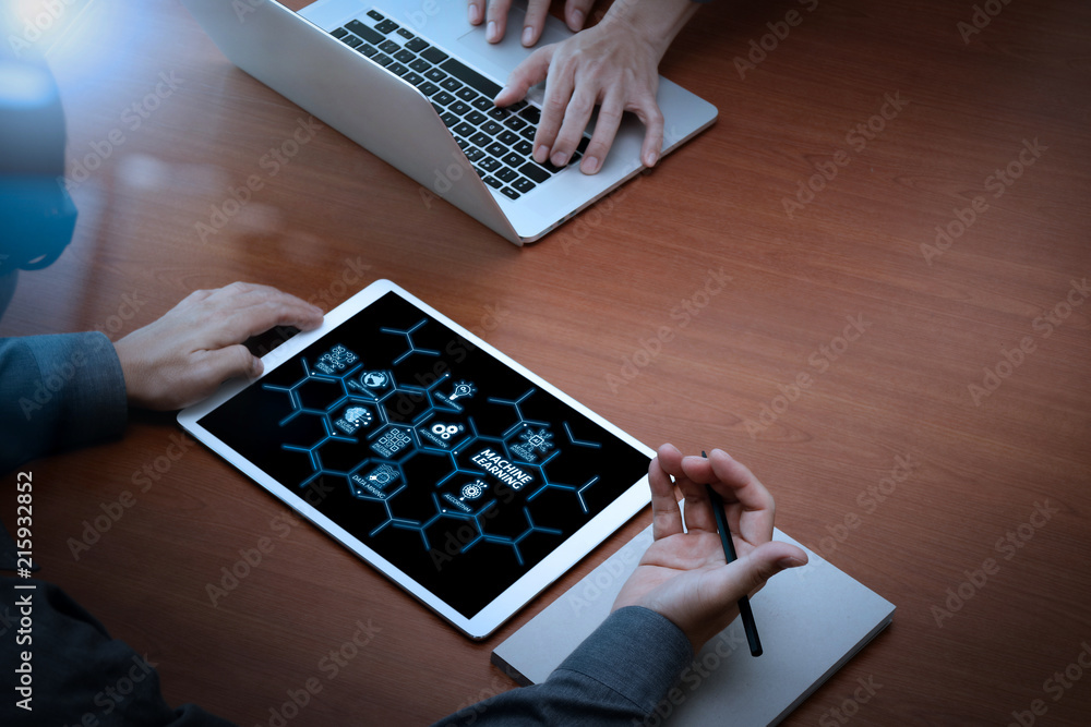 Poster top view of two colleagues discussing data with new modern computer laptop and pro digital tablet on