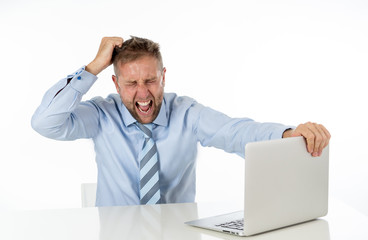 Business, people, deadline and technology concept - stressed entrepreneur businessman with laptop computer at office feeling angry and desperate.