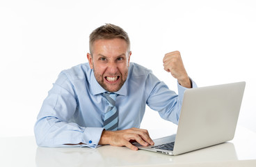 Business, people, deadline and technology concept - stressed entrepreneur businessman with laptop computer at office feeling angry and desperate.