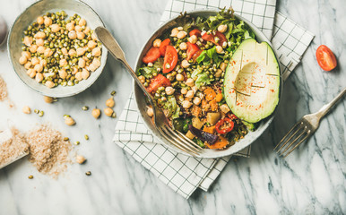 Vegan lunch bowl. Flat-lay of dinner with avocado, grains, beans, sprouts, greens and vegetables...