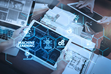 top view of two colleagues interior designers discussing data with blank screen new modern computer laptop and pro digital tablet with sample material on wooden desk as concept