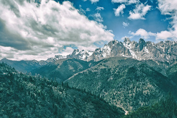 Big snow stone mountain and forest mountain with blue sky and cloudy