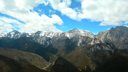 Fototapeta premium Big snow stone mountain and forest mountain with blue sky and cloudy