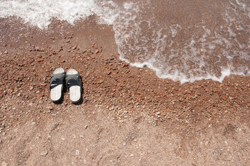 Beach slippers in the sand on beach