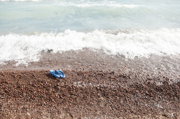 Fototapeta na wymiar Beach slippers in the sand on beach