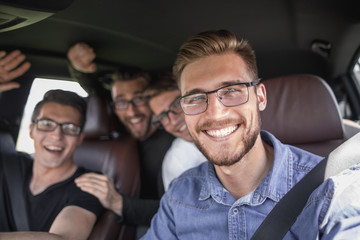 four friends traveling in the car