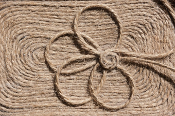 Background made of natural string with a charming flower.