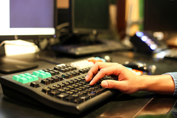 Businessman hands typing on  keyboard in studio TV station, Audio and Video Production Switcher of...