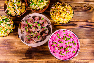 Different festive dishes on a wooden table. Top view
