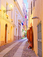 Fototapeta premium Beautiful narrow alley in the old town of Alghero. Sardinia, Italy.