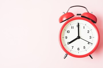Red vintage alarm Clock show 8 O'Clock with copy space on pink background