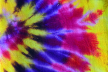 Obraz na płótnie Canvas colorful draped tie dyed fabric textile pattern background
