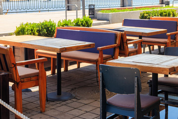 Chairs and tables in cozy outdoor cafe at summer