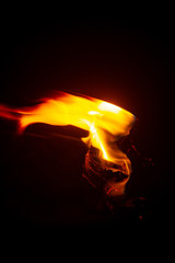 Torch Flame in the Darkness, Close up Low Key Torch with Detail of Burned Fabric