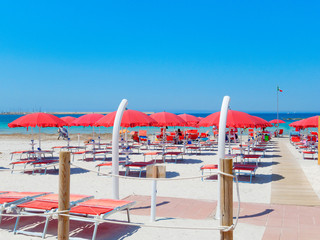 Alghero beach, Sardinia. Italy. Sea view, umbrellas and sun loungers.