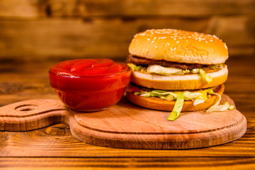 Hamburger and sauce on a wooden table