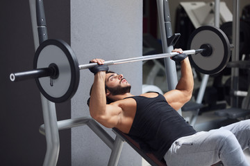 Fototapeta na wymiar Weightlifter or bodybuilder lifting weights