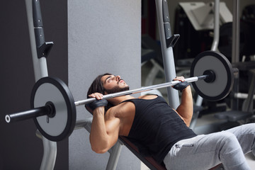 Fototapeta na wymiar Weightlifter or bodybuilder lifting weights
