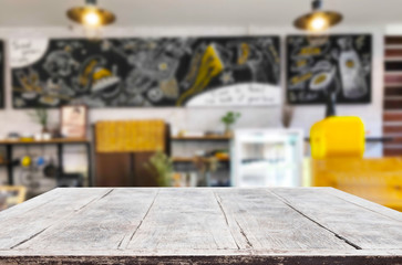 Selected focus empty brown wooden table and Coffee shop or restaurant blur background with bokeh image. for your photomontage or product display