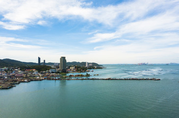 Aerial view of sea beach with city and island background