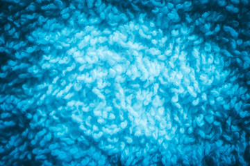 A white bath towel, blue abstract soft texture closeup.