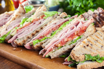 Sandwiches with ham, cheese, tomatoes, lettuce and cucumber