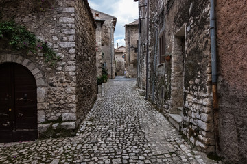 Fototapeta na wymiar Stone timeworn walls of an old town.