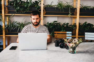 Man using laptop at table in modern design