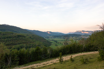 Fototapeta na wymiar Landscape with valley and hiking trail in the sunset, Vercors, France