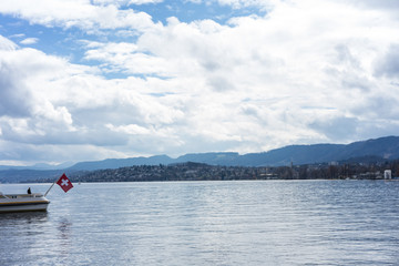 lake zurich with swiss national flag