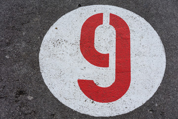 red number nine in white circle road sign