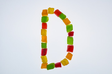 english alphabet of candied fruits on white background