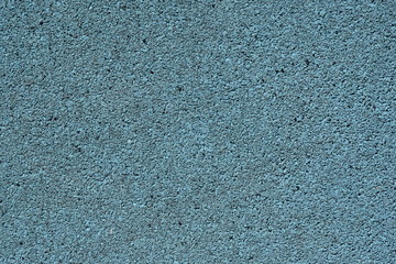 Background image of a colored rubber coating blue. Worn sports field cover