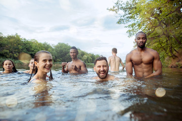 Enjoying river party with friends. Group of beautiful happy young people at the river together