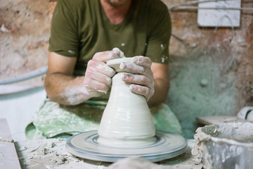 Ceramic dishes in working process. Creating ceramic pieces. Tradicional ceramic factory in spain. man working with traditional potter's wheel