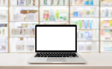 Laptop computer blank screen on pharmacy counter drugstore shop interior