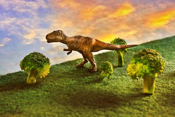 Tyrannosaurus rex or t-rex infront colorful sky and foliage in background
