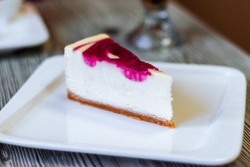 delicious cheesecake with cherry cream on a white plate