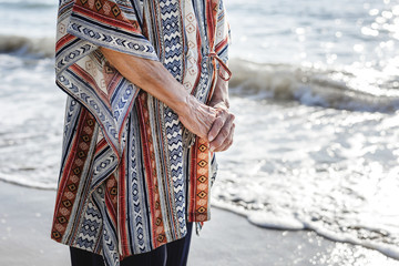 Mature woman standing at the beach