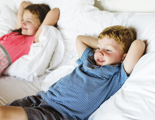Fototapeta premium Little kids lying on the bed