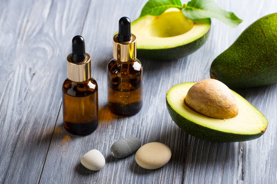 avocado oil cosmetics medicine  health  nature glass vial wooden background
