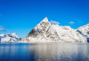 Obraz na płótnie Canvas A view of mount Olstind on the Lofoten islands on a glorious sunny winter morning