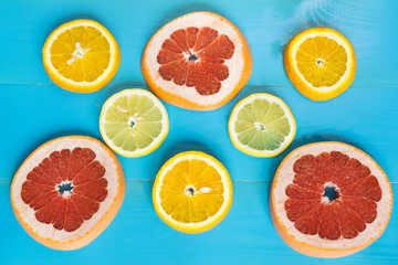 Citrus composition, orange, grapefruit and lemon on the blue wooden background.