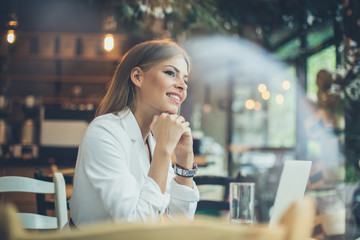 Smiling woman at cafe.