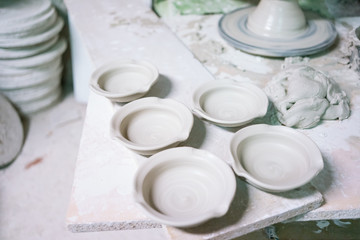 Ceramic dishes in working process. Creating ceramic pieces. Tradicional ceramic factory in spain. man working with traditional potter's wheel
