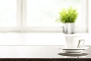 desk of free space and window background with small plant 
