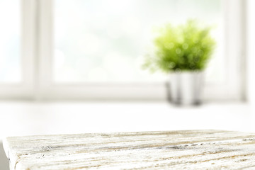 desk of free space and window background with small plant 