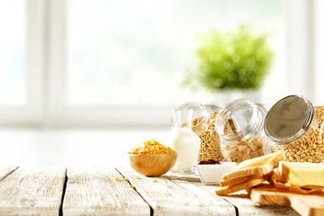 Continental breakfast and blurred background of white window with green plant. Free space for your...