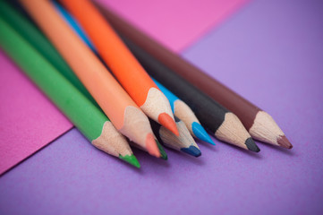 closeup of colouring pencils on color background