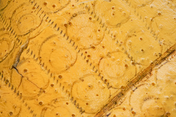 Texture of old yellow foam rubber with traces of springs